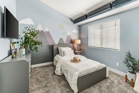 a bedroom with a bed and a potted plant