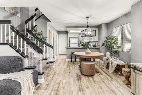 a view of a livingroom with furniture wooden floor and a chandelier