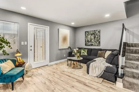 a living room with furniture and a large window