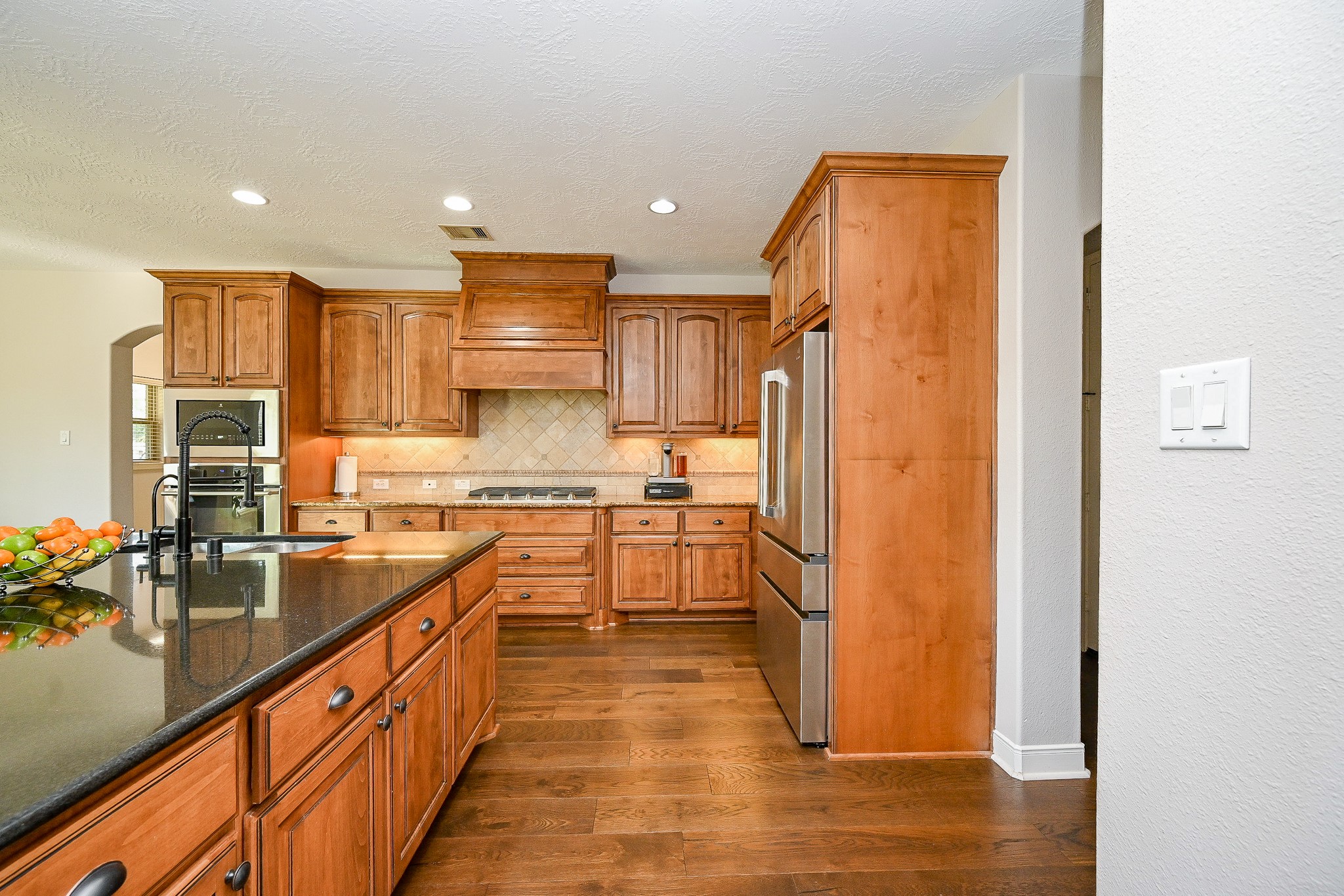 17607 Astrachan Road Richmond, TX 77407 - Photo 11 of 50 a kitchen with stainless steel appliances granite countertop a refrigerator and a stove top oven