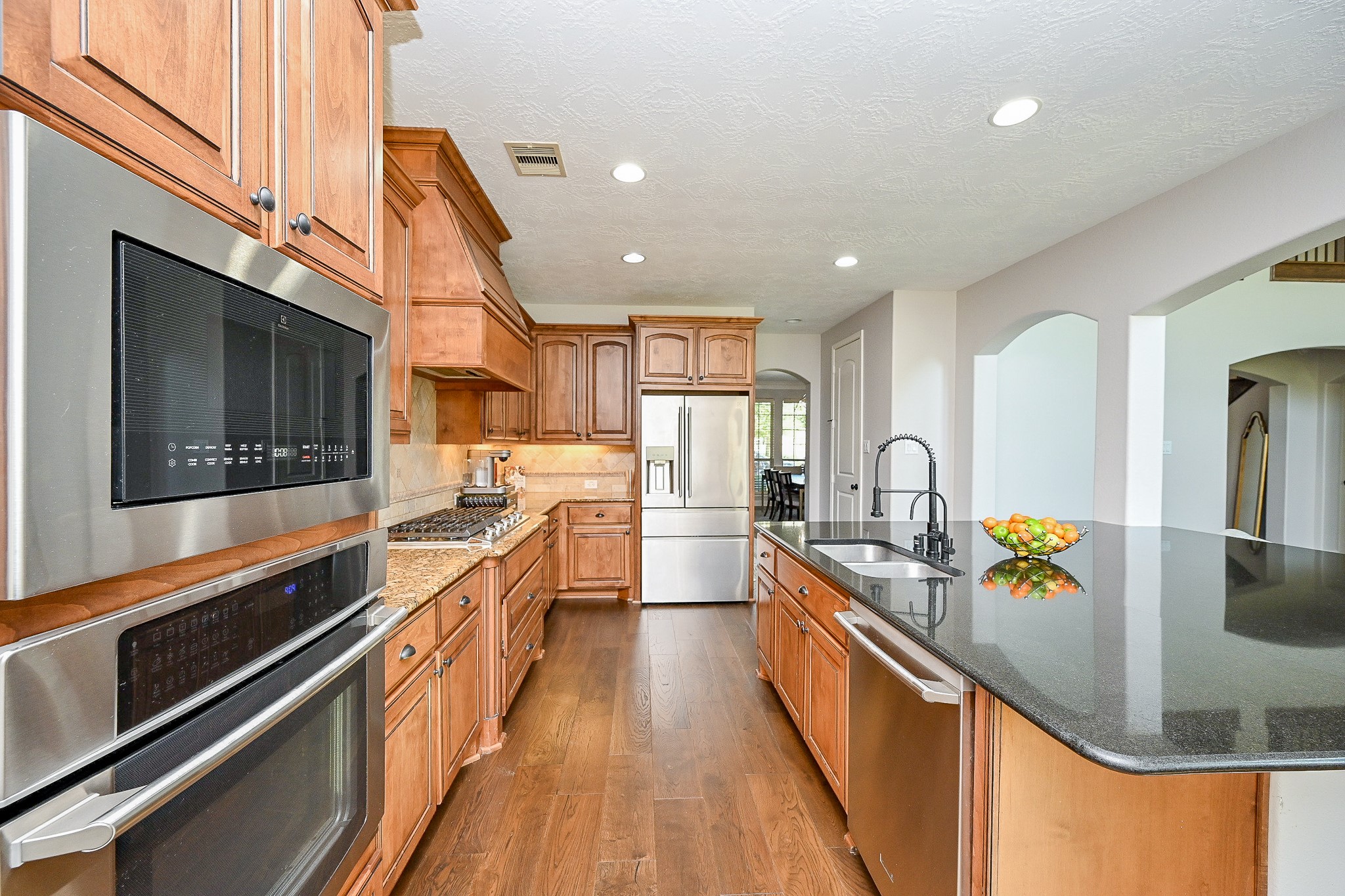 17607 Astrachan Road Richmond, TX 77407 - Photo 13 of 50 a kitchen with stainless steel appliances granite countertop sink stove and refrigerator