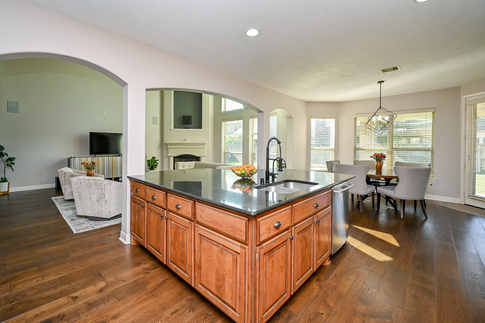 17607 Astrachan Road Richmond, TX 77407 - Photo 15 of 50 a kitchen with stainless steel appliances granite countertop a stove and a living room