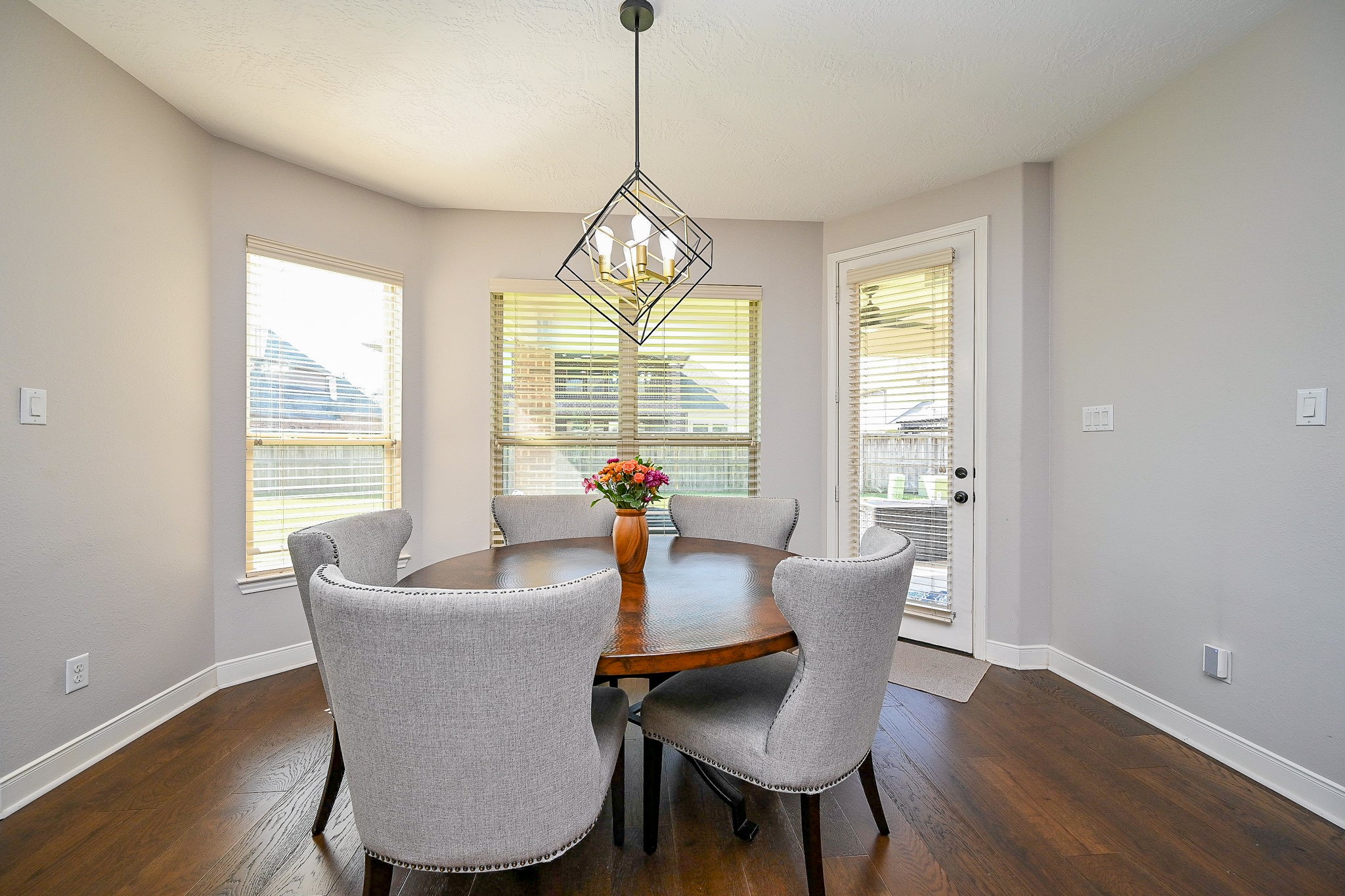 17607 Astrachan Road Richmond, TX 77407 - Photo 16 of 50 a view of a dining room with furniture wooden floor and a chandelier