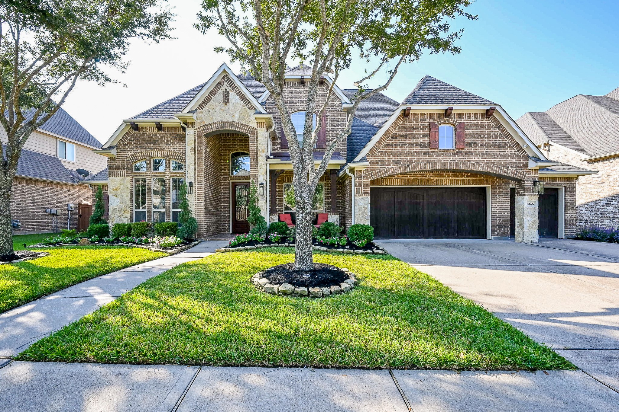 17607 Astrachan Road Richmond, TX 77407 - Photo 2 of 50 a front view of a house with a garden and trees