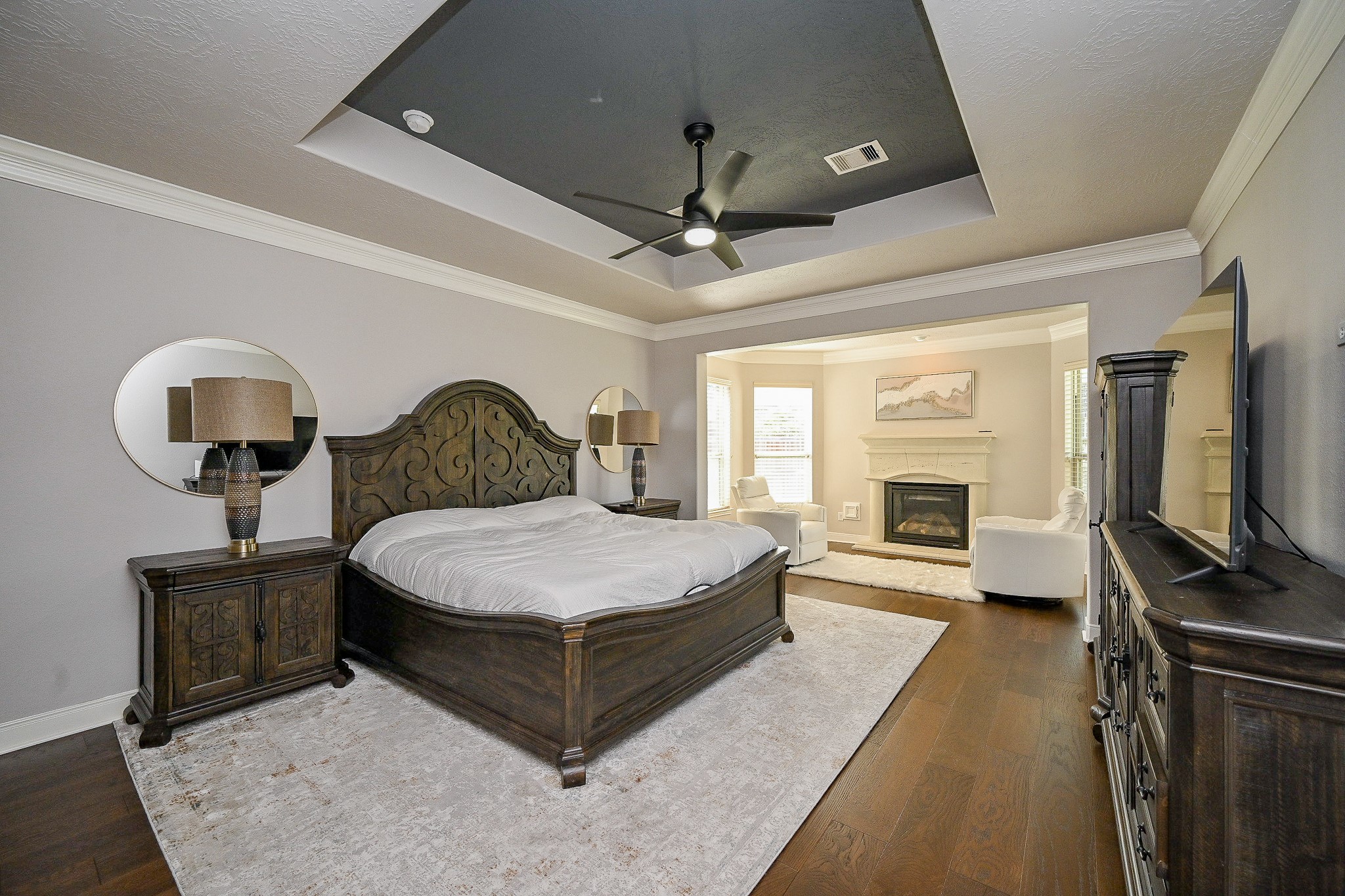17607 Astrachan Road Richmond, TX 77407 - Photo 22 of 50 a bedroom with a bed wooden floor and flat screen tv