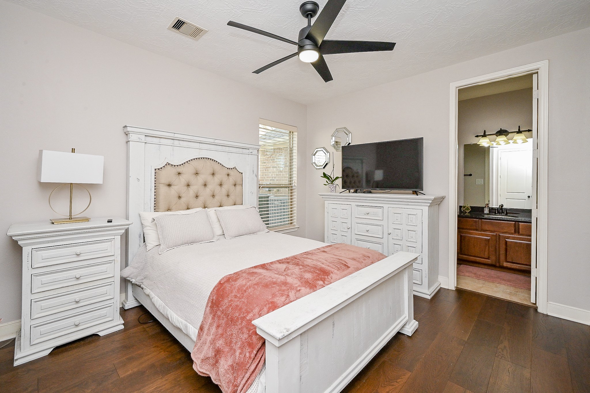 17607 Astrachan Road Richmond, TX 77407 - Photo 28 of 50 a spacious bedroom with a bed and a flat screen tv