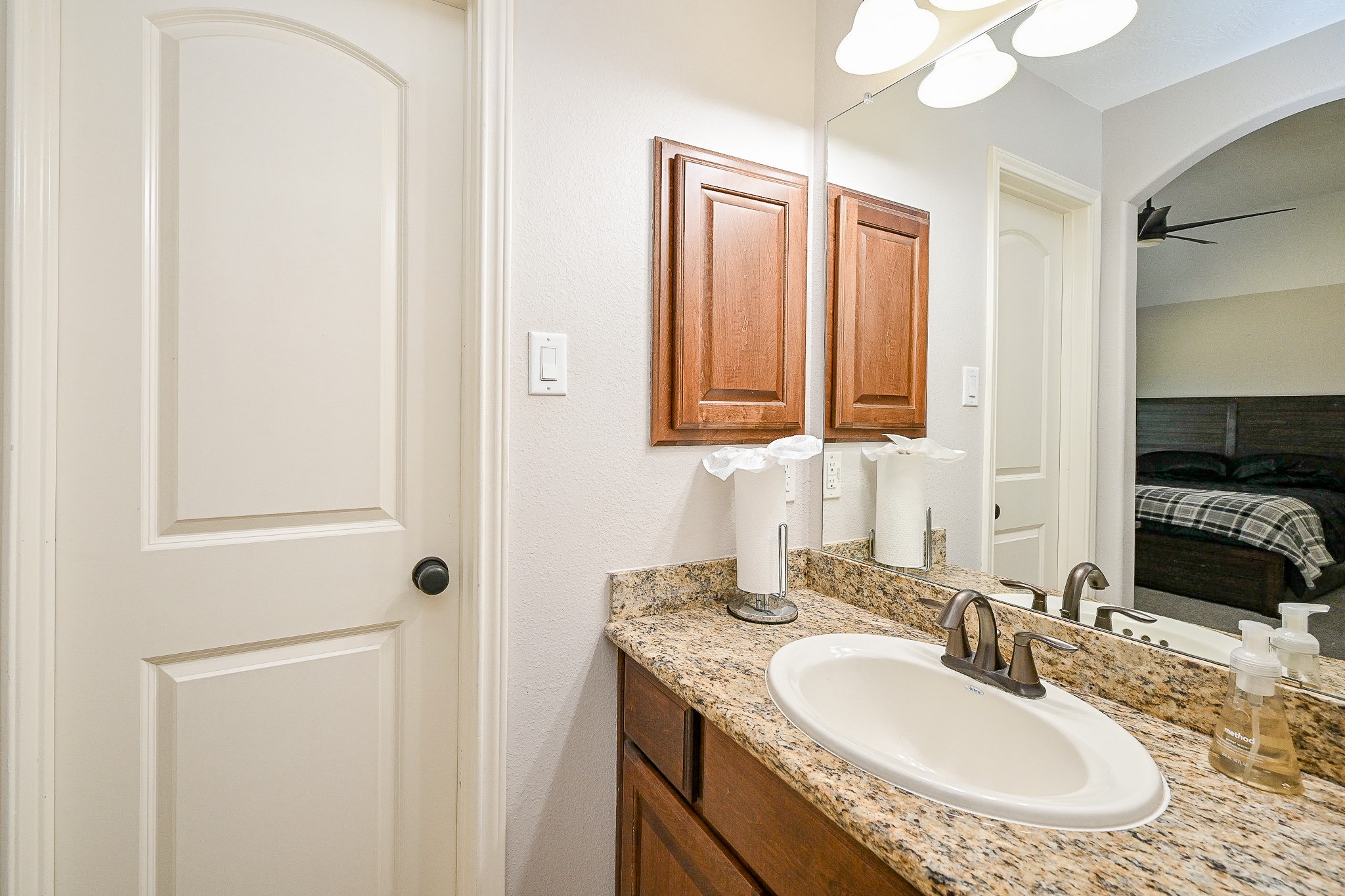 17607 Astrachan Road Richmond, TX 77407 - Photo 36 of 50 a bathroom with a granite countertop sink and a mirror