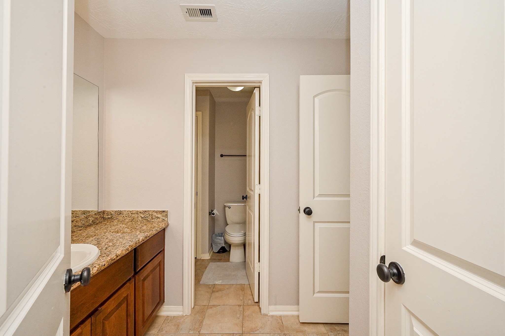 17607 Astrachan Road Richmond, TX 77407 - Photo 38 of 50 a bathroom with a granite countertop sink and a mirror