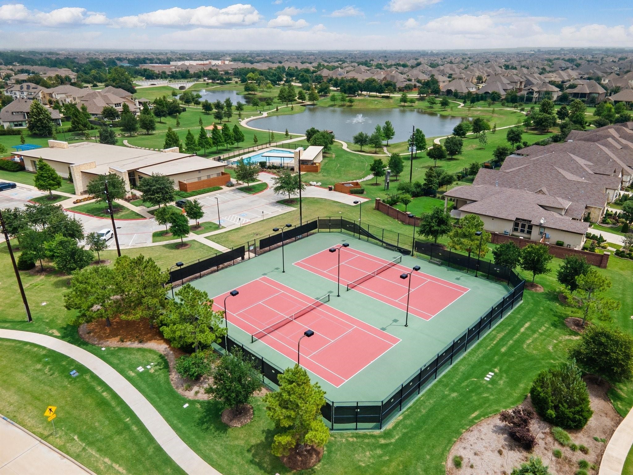 17607 Astrachan Road Richmond, TX 77407 - Photo 49 of 50 an aerial view of a house with pool lake view and mountain view