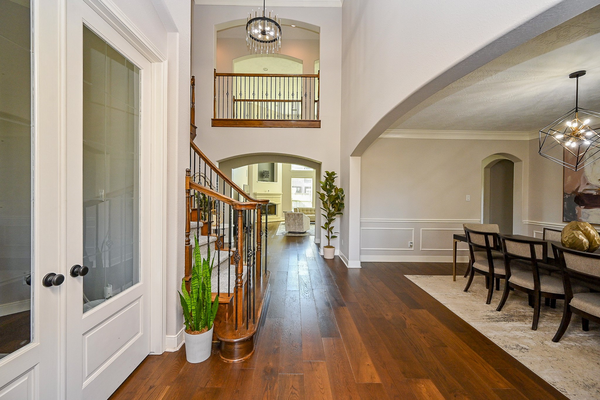 17607 Astrachan Road Richmond, TX 77407 - Photo 5 of 50 a view of a hallway with wooden floor windows a fireplace and kitchen view