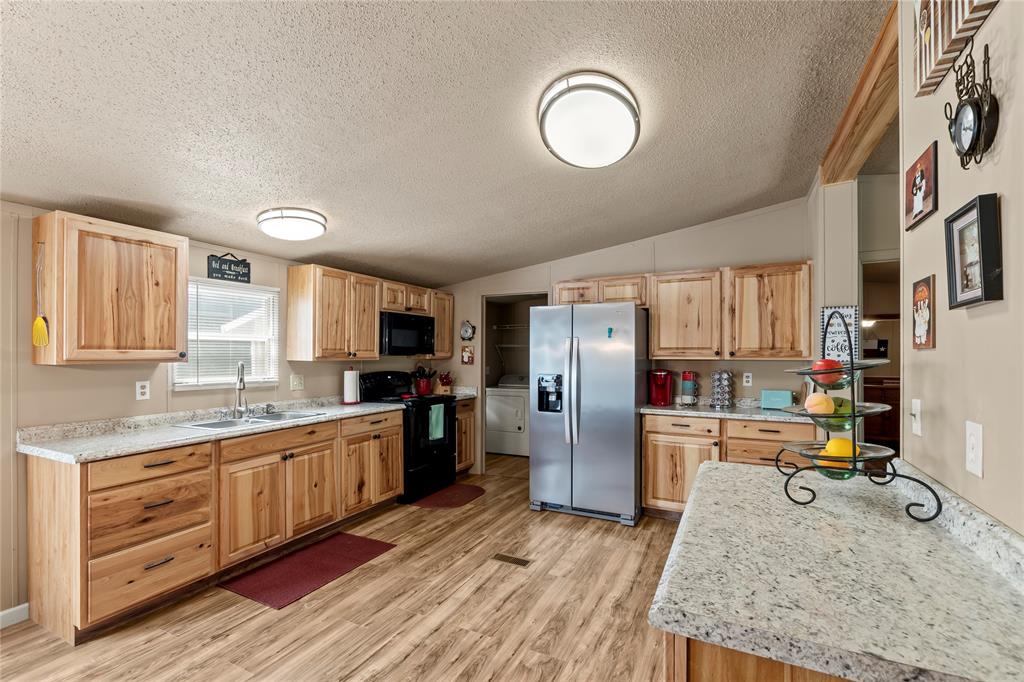 194 Indian Gap Road Mabank, TX 75156 - Photo 5 of 18 a kitchen with refrigerator cabinets and wooden floor