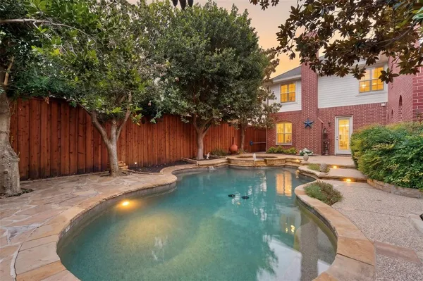 a swimming pool with outdoor seating and yard
