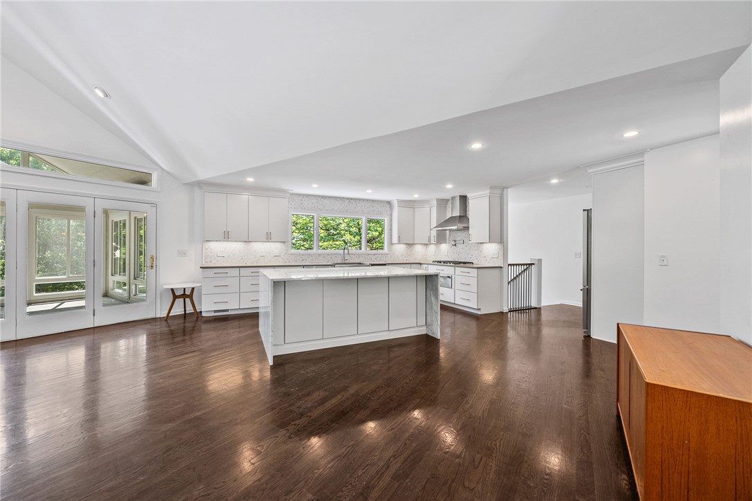 118 Beacon Ridge Circle Salem, SC 29676 - Photo 6 of 45 A well-lit kitchen with dark hardwood flooring and white cabinetry creates a warm and inviting atmosphere.