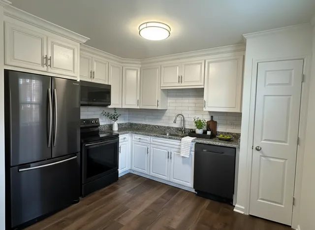 a view of staircase with wooden floor and white walls