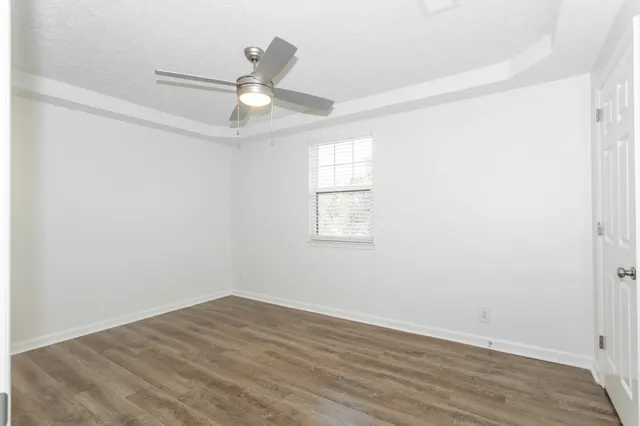 a bathroom with a granite countertop sink a toilet and a bathtub