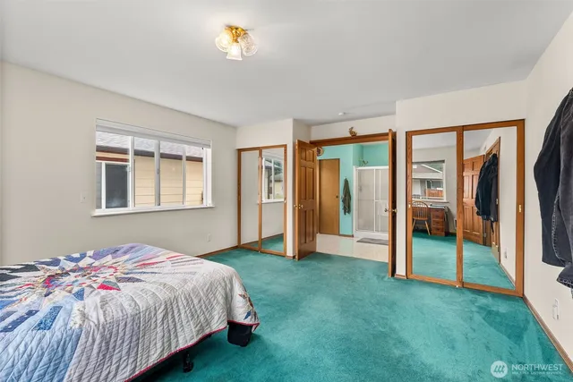 a spacious bedroom with a bed and a window