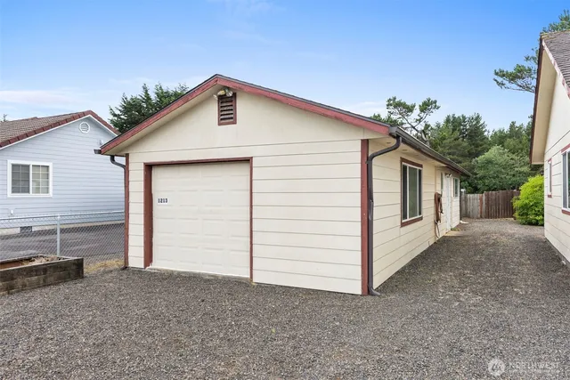 a view of a house with a yard and garage