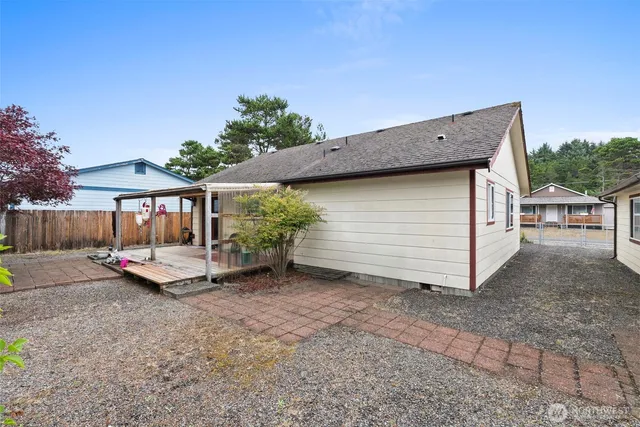 a view of a house with backyard and sitting area