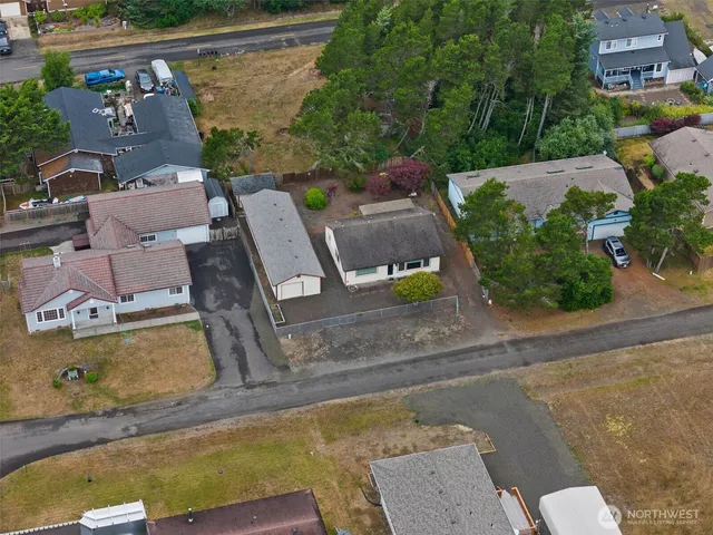 an aerial view of a house with garden space and street view