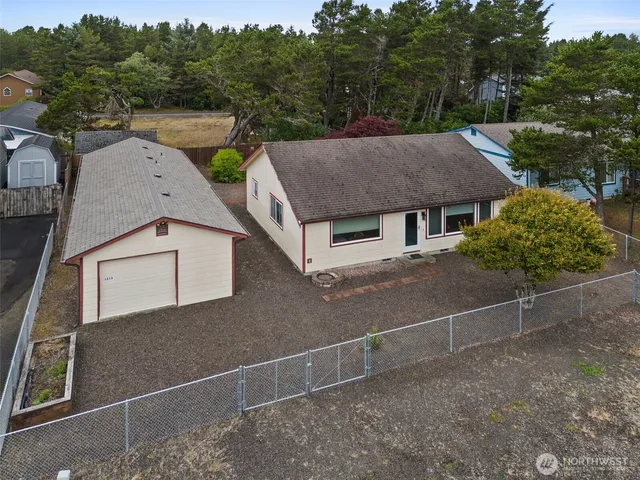 an aerial view of a house with a yard and garage