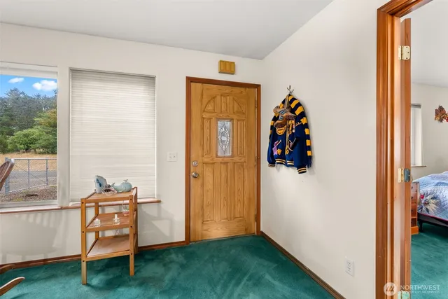 a view of a hallway with closet and front door
