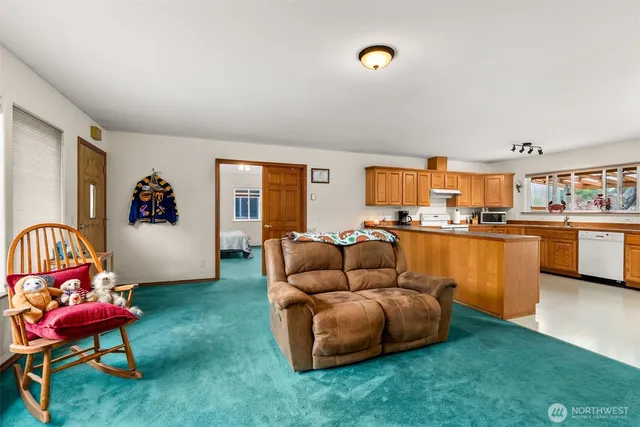 a living room with furniture and kitchen view