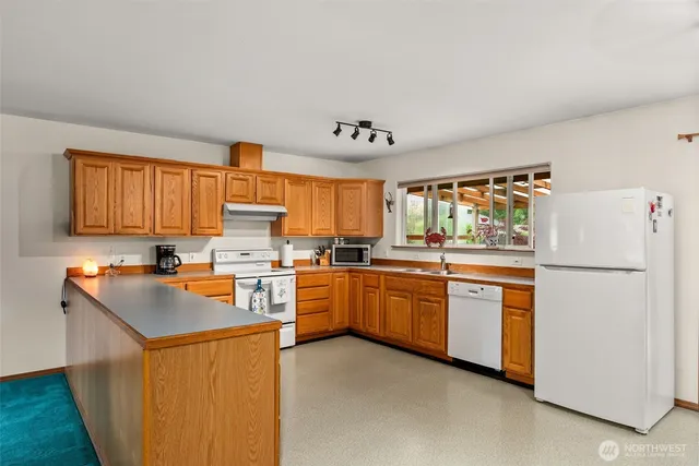 a kitchen with stainless steel appliances granite countertop a refrigerator sink and cabinets