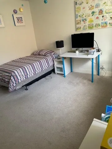 a living room with a couch and a desk