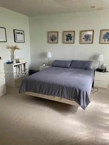 a bedroom with a bed and wall painting