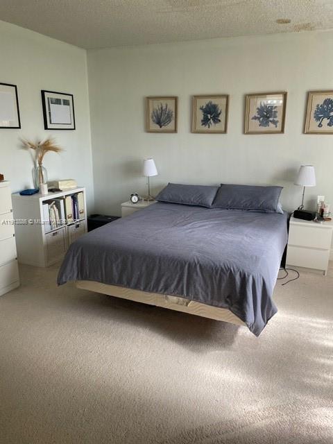 17911 Northwest 68th Avenue, Unit P102 Hialeah, FL 33015 - Photo 6 of 9 a bedroom with a bed and wall painting