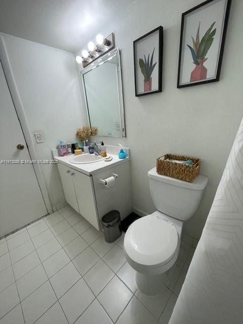 17911 Northwest 68th Avenue, Unit P102 Hialeah, FL 33015 - Photo 9 of 9 a bathroom with a sink mirror vanity and toilet