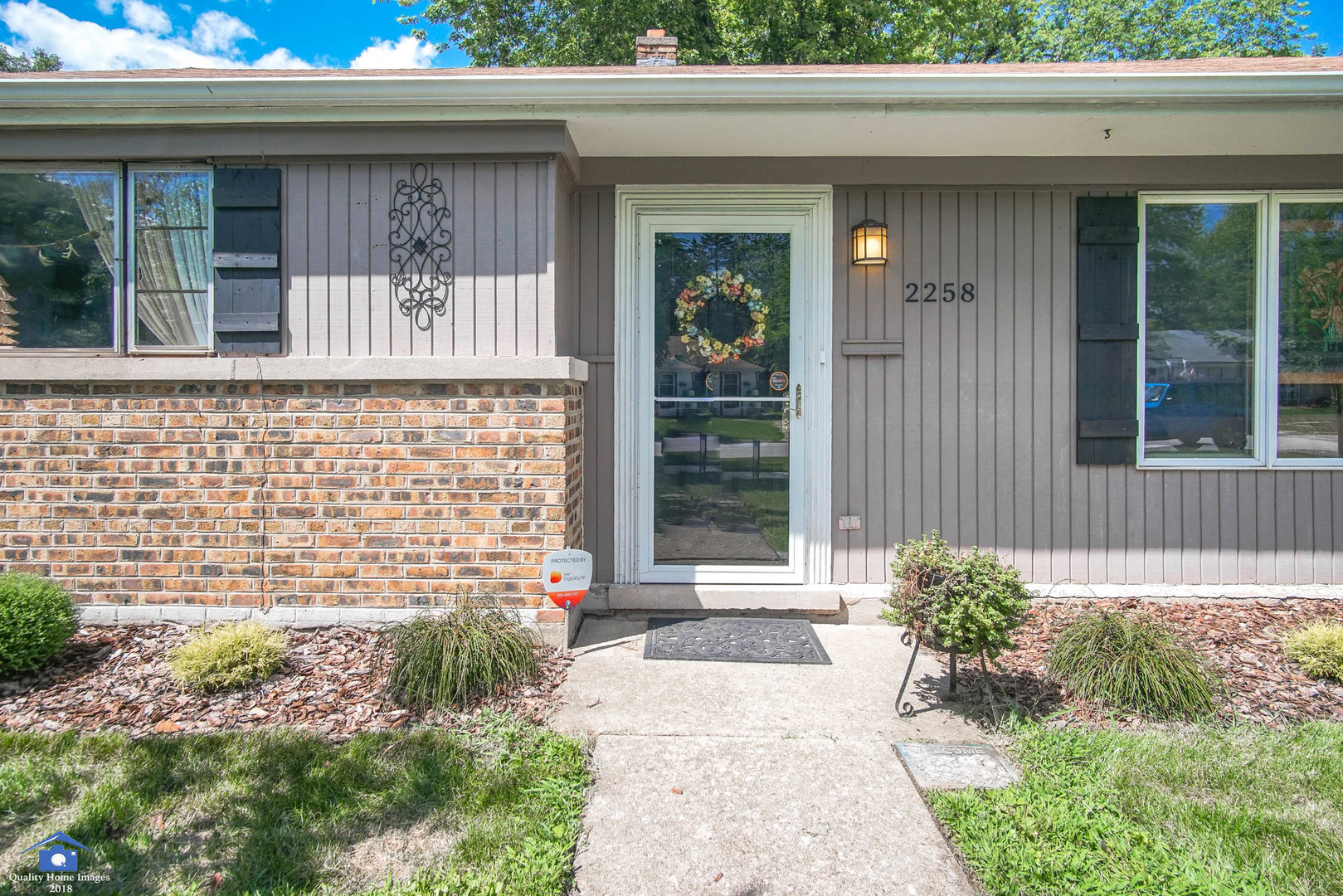 2258 Spruce Road Homewood, IL 60430 - Photo 2 of 19 a front view of a house with a garden