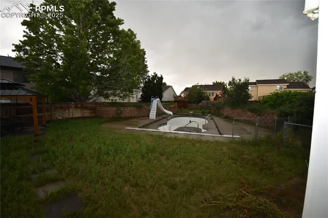 a view of a backyard with a garden and entertaining space