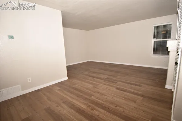 an empty room with wooden floor