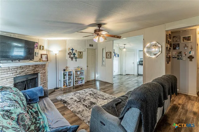 a living room with furniture a flat screen tv and a fireplace