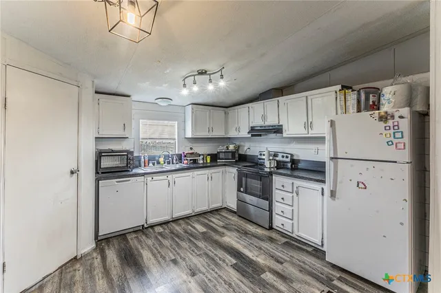 a kitchen with cabinets and stainless steel appliances