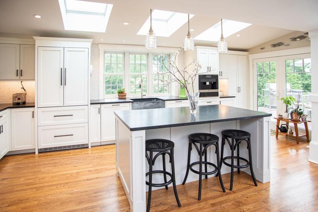 14 Hillsea Road Yarmouth, MA 02675 - Photo 11 of 42 a open kitchen with granite countertop a stove top oven a sink and dining table with wooden floor