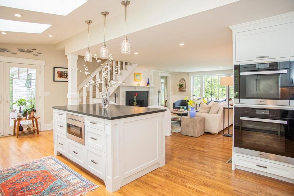 14 Hillsea Road Yarmouth, MA 02675 - Photo 12 of 42 a kitchen with stainless steel appliances granite countertop a stove top oven a sink dishwasher a dining table and chairs with wooden floor