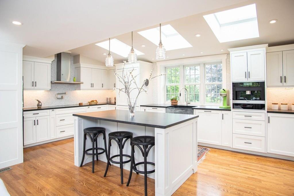 14 Hillsea Road Yarmouth, MA 02675 - Photo 10 of 42 a kitchen with stainless steel appliances granite countertop a stove a sink and white cabinets with wooden floor