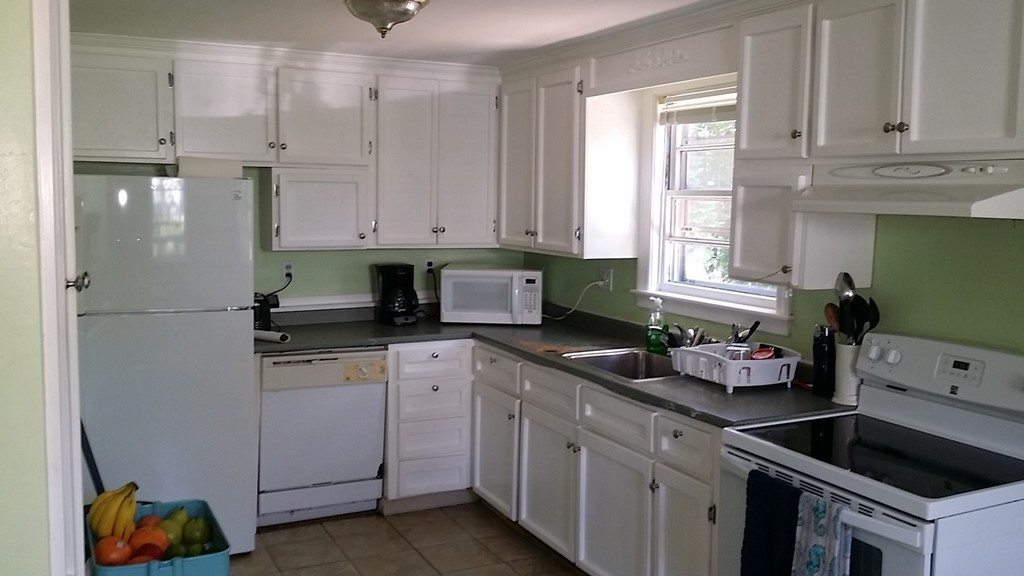 41 Audrea Road Framingham, MA 01701 - Photo 3 of 10 a kitchen with white cabinets and window