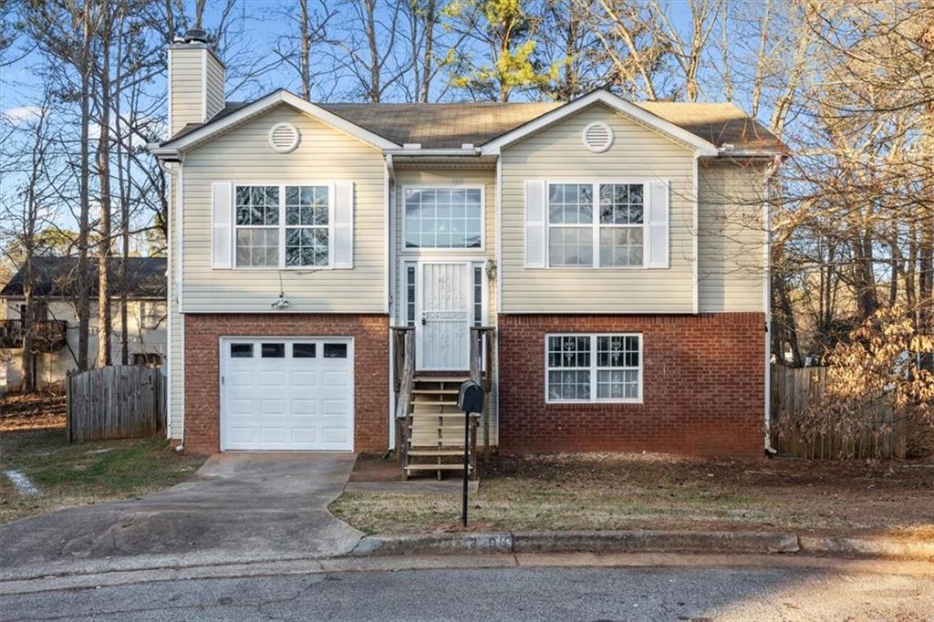 3296 Basking Shade Lane Decatur, GA 30034 - Photo 1 of 1 a front view of a house with a yard and garage