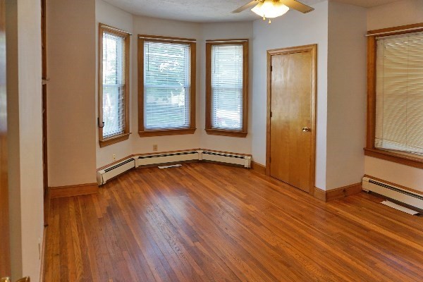 85 Brown Street, Unit 1 Waltham, MA 02453 - Photo 4 of 7 a view of a room with wooden floor and window