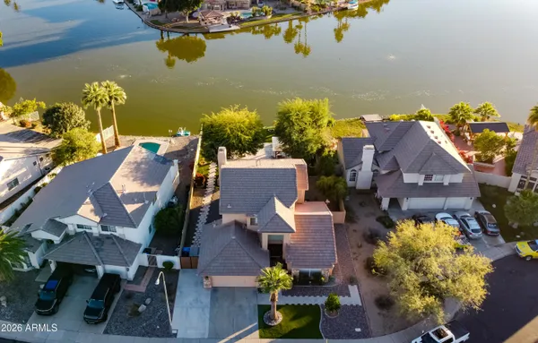 an aerial view of a house with a swimming pool ocean view