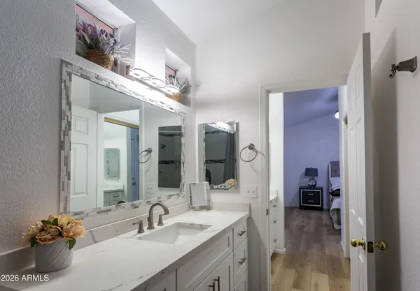 a en suite bathroom with a sink double vanity and a mirror