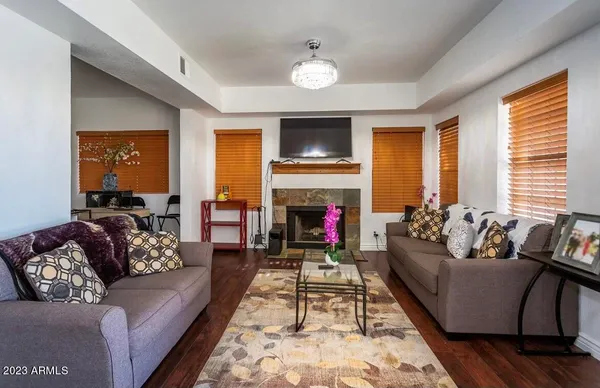 a living room with furniture fireplace and flat screen tv