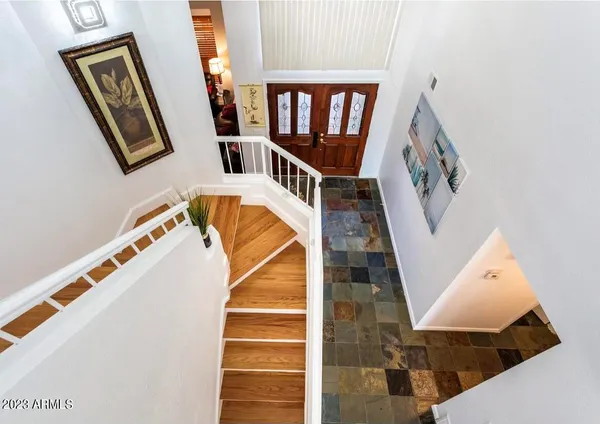a view of staircase with railing and white walls
