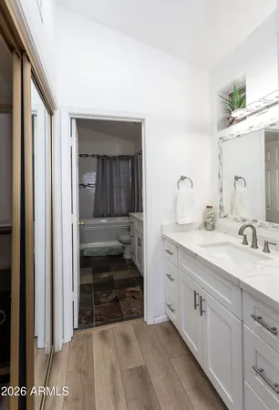 a spacious bathroom with a sink and a mirror