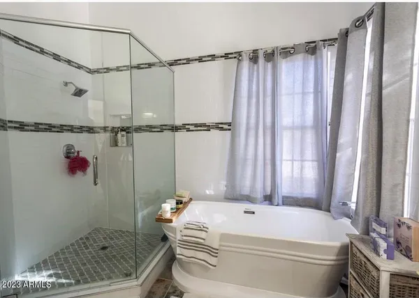 a bathroom with a granite countertop bathtub and shower