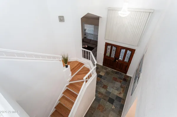 a view of stairs and hall with wooden floor