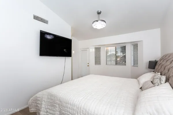 a bedroom with a bed and a flat screen tv